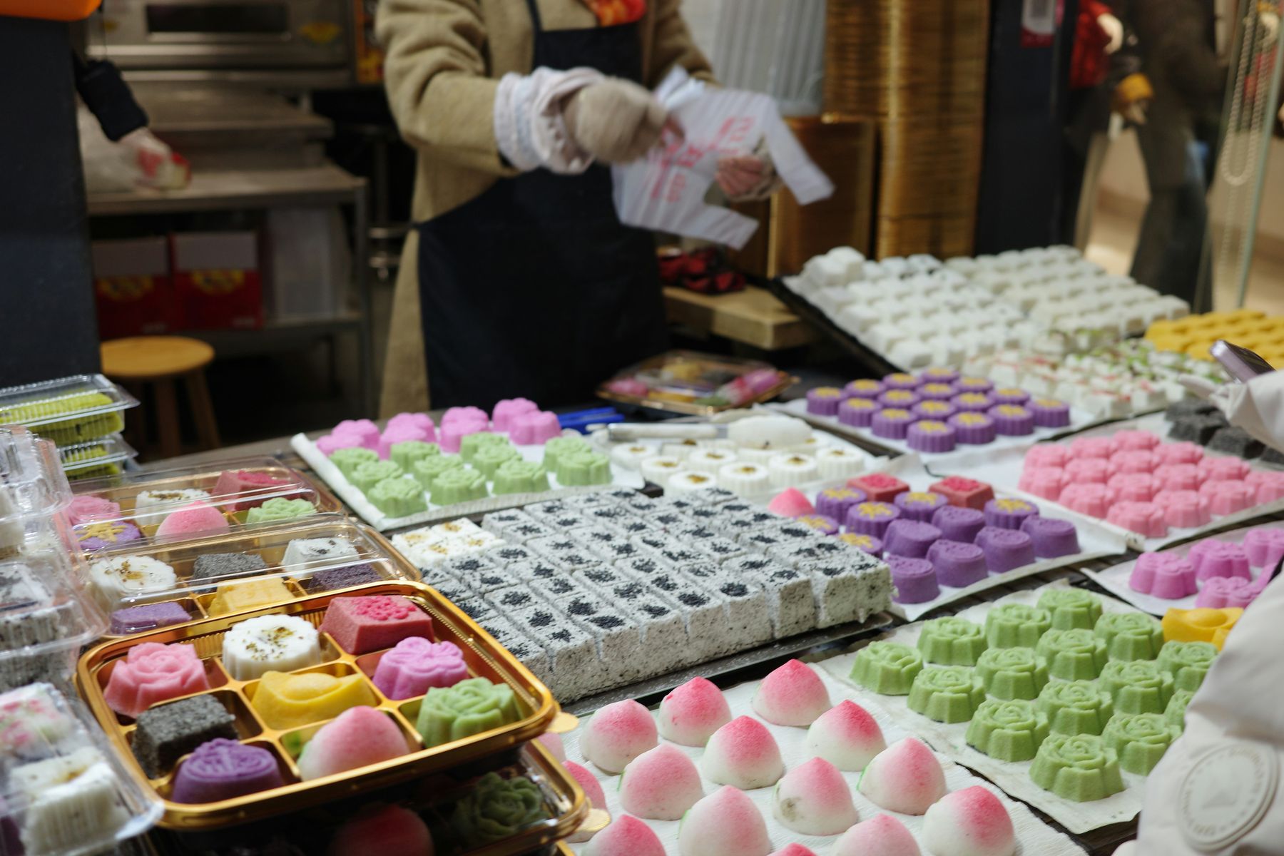 Colorful assorted sweets and pastries displayed on a market stall